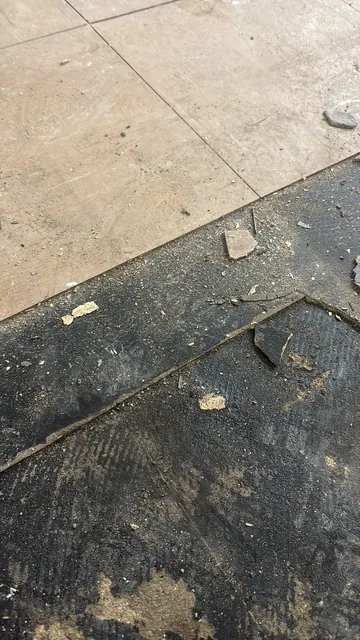 Black bitumen mastic floor removal in a SW13 flat
